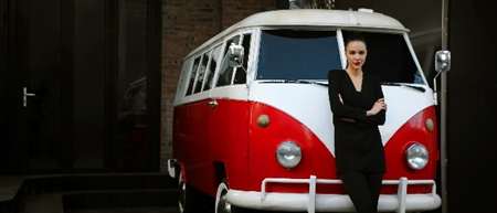 A person leaning against a van

Description automatically generated with medium confidence