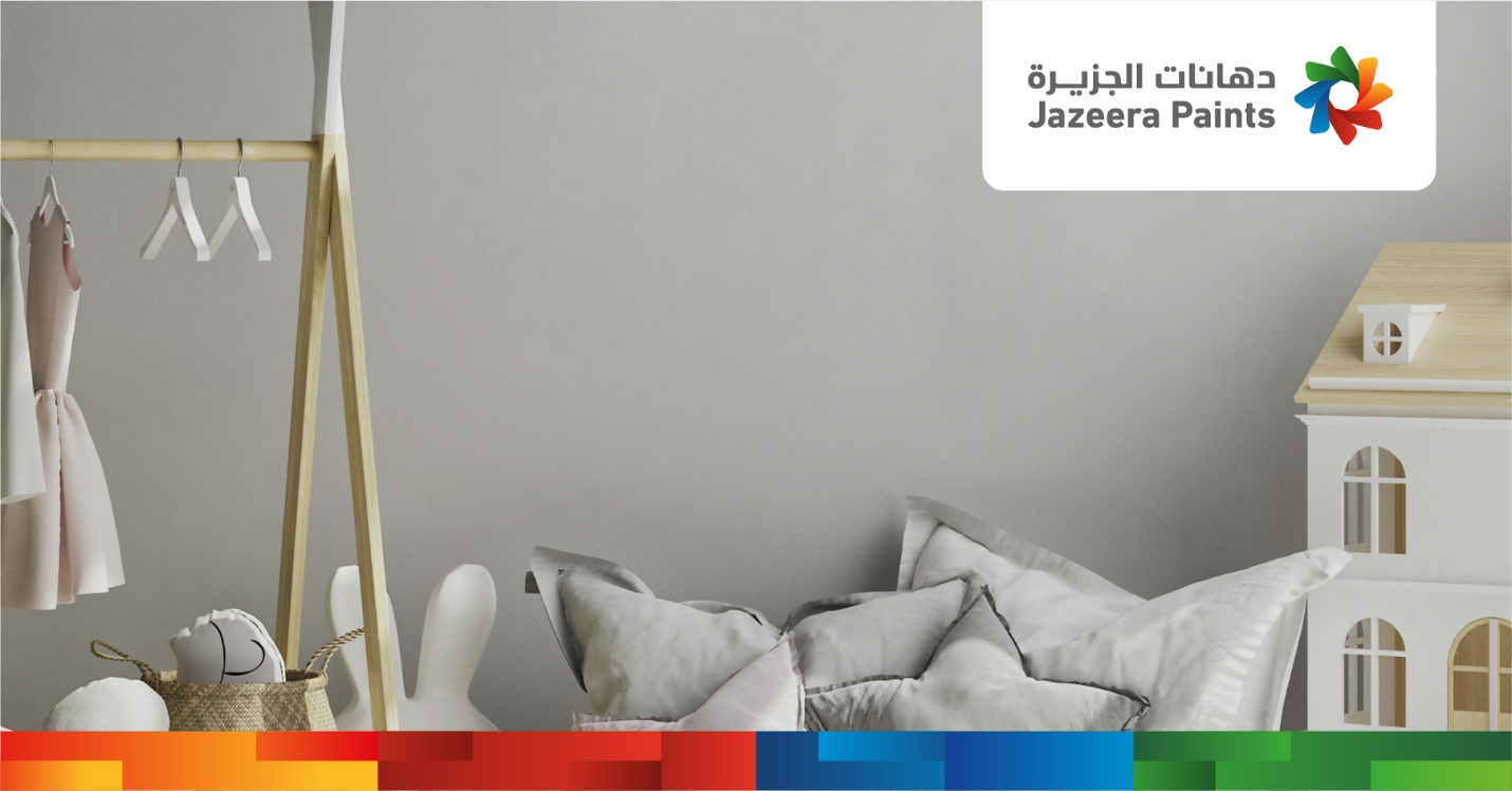 A white and grey pillow next to a white wall

Description automatically generated